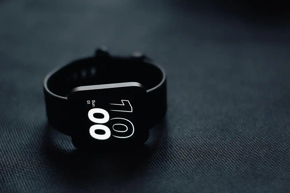 Ecran de smartwatch cu culori vii, văzut de aproape, cu cadranul digital aprins