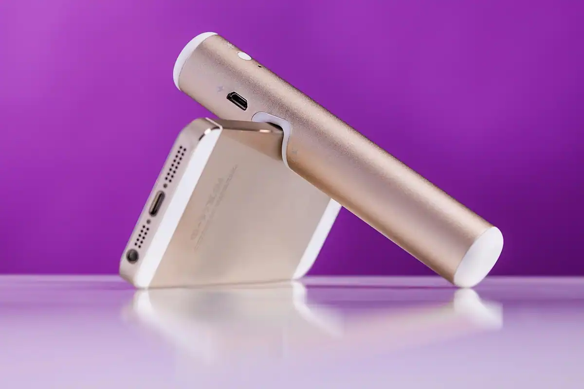 Laptop conectat la un încărcător USB-C pe un birou, cu cablul introdus în port